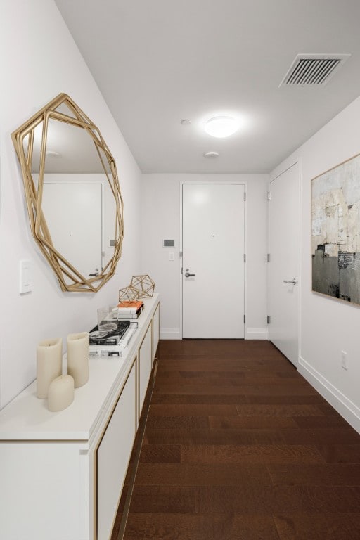 corridor with dark wood-type flooring