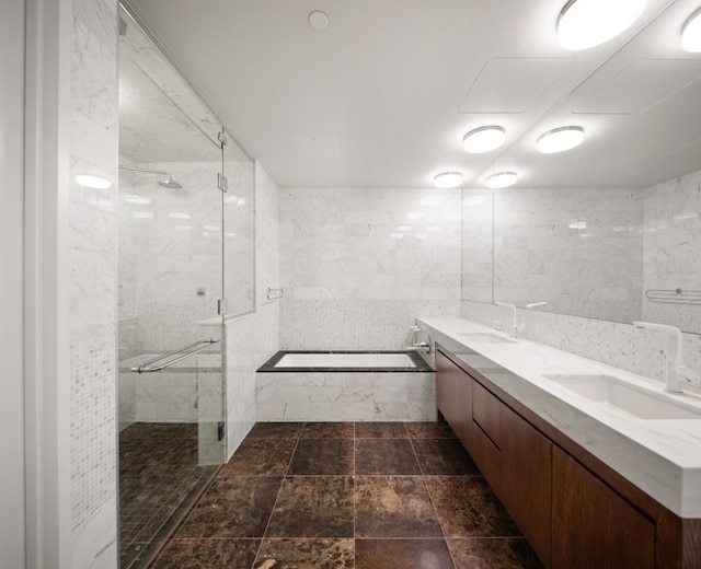 bathroom featuring separate shower and tub, tile walls, and vanity