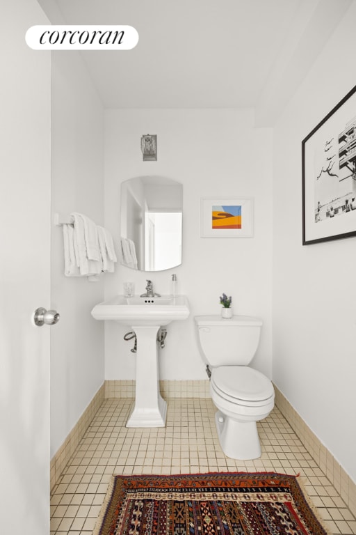 bathroom with tile patterned floors and toilet