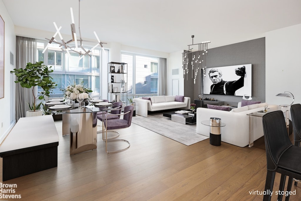 living area featuring a chandelier and wood finished floors