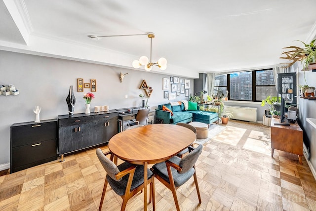 dining space featuring light parquet floors, an inviting chandelier, and ornamental molding