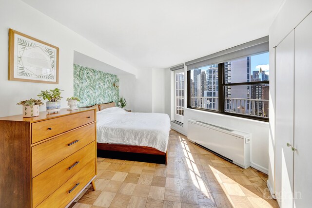 bedroom with radiator and a closet