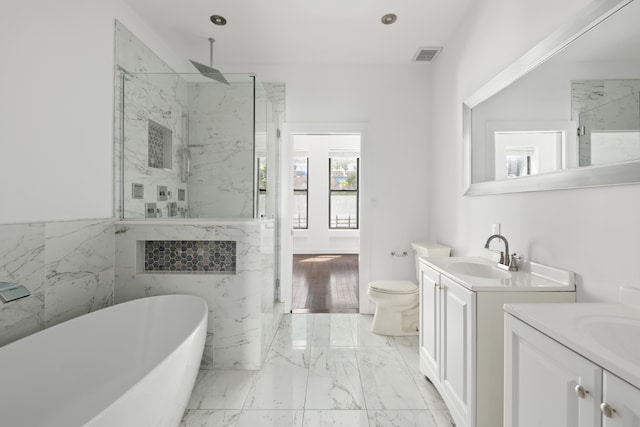 full bathroom featuring vanity, separate shower and tub, tile walls, and toilet