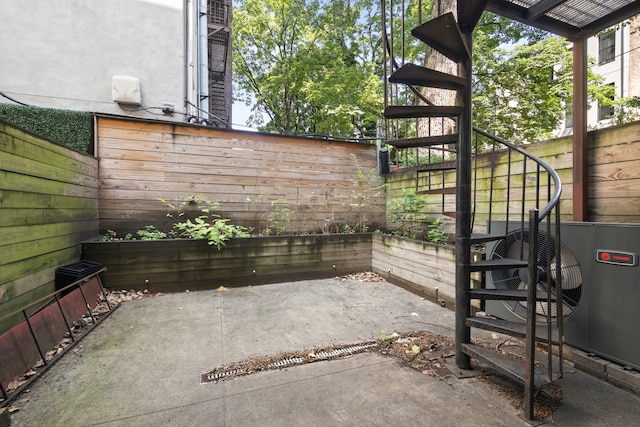 view of patio / terrace featuring stairs and a fenced backyard