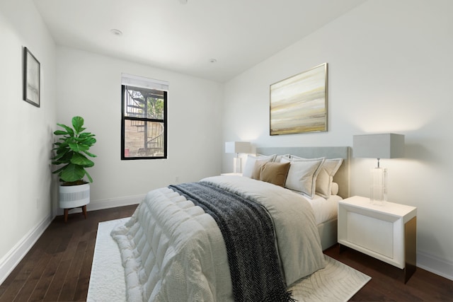 bedroom with dark hardwood / wood-style floors