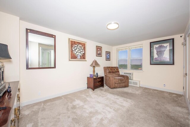 living area featuring light carpet