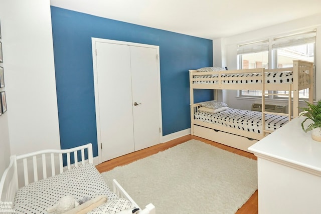 bedroom featuring light hardwood / wood-style floors and a closet