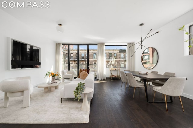 living room featuring dark wood-type flooring and a wall of windows