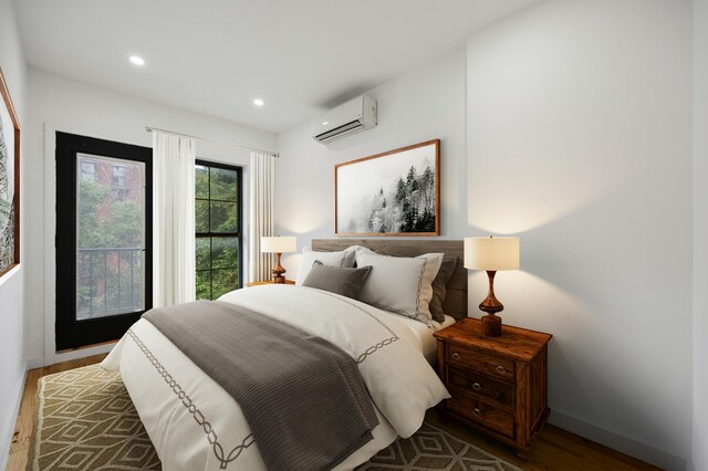 bedroom featuring an AC wall unit, recessed lighting, baseboards, and wood finished floors