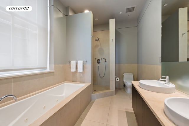 bathroom featuring a sink, visible vents, a tub with jets, and tile patterned flooring