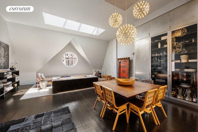 dining room featuring visible vents, vaulted ceiling with skylight, dark wood-type flooring, and a notable chandelier