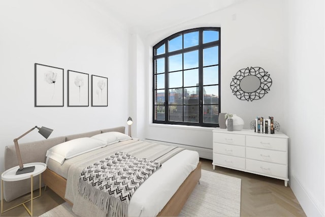 bedroom featuring parquet flooring