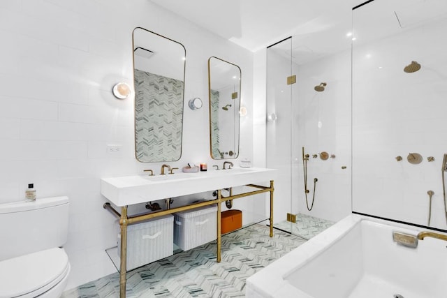 bathroom with tile walls, toilet, and tiled shower