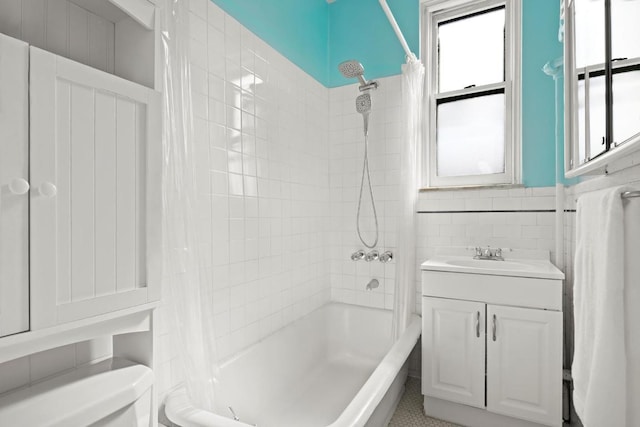 full bathroom featuring tile walls, vanity, toilet, and shower / bathtub combination with curtain