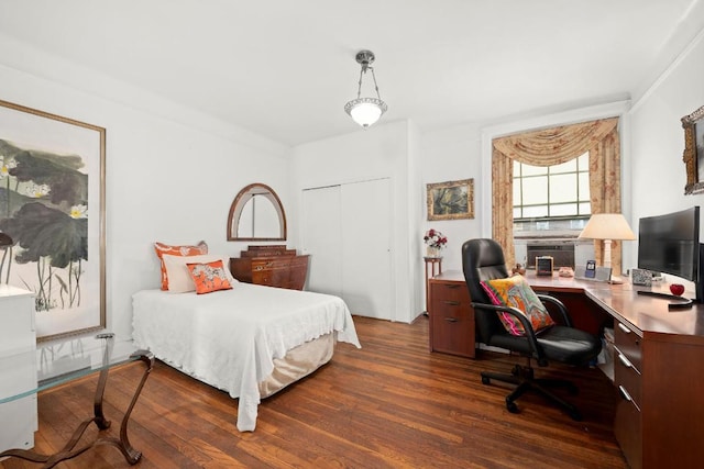 bedroom featuring dark hardwood / wood-style flooring and a closet