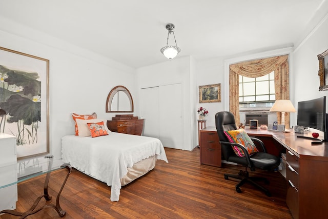 bedroom with dark wood-style floors and a closet