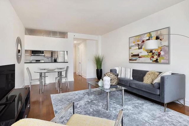 living room featuring wood finished floors and baseboards