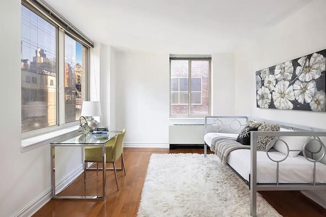 living area featuring baseboards and wood finished floors