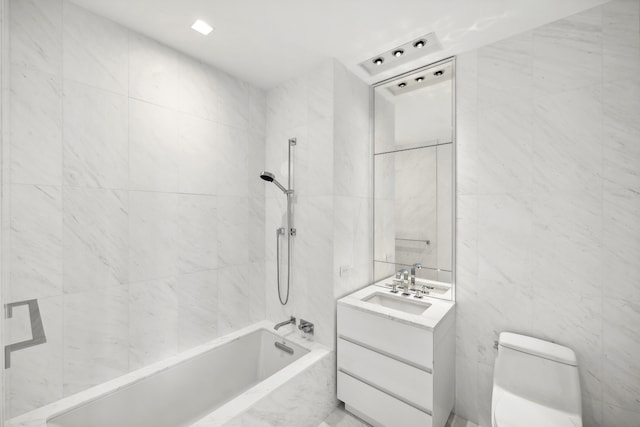 full bathroom featuring tile walls, a combined bath / shower with marble appearance, vanity, and toilet