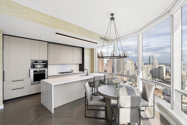 kitchen featuring a view of city, a healthy amount of sunlight, modern cabinets, and light countertops