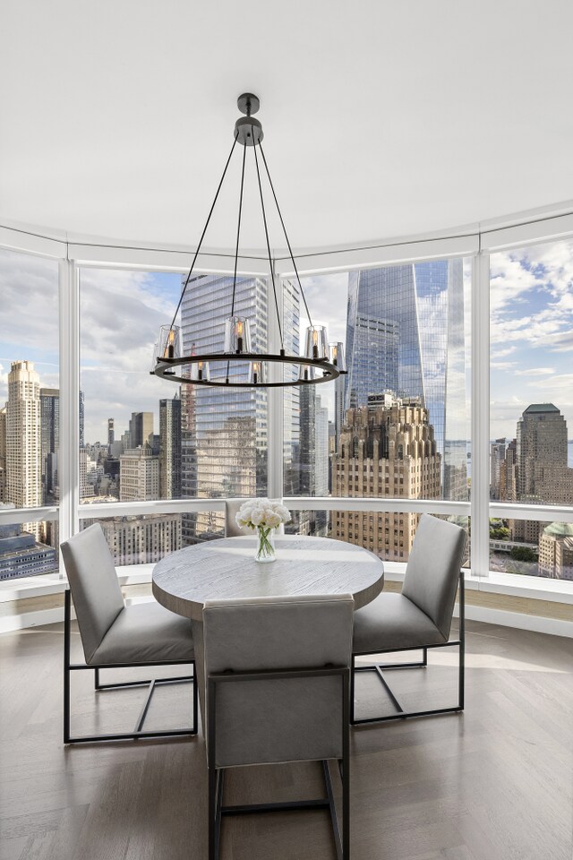 dining space with a view of city and a chandelier