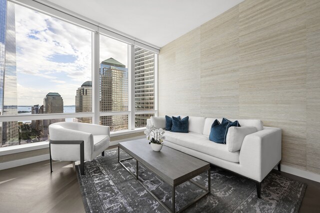 living room featuring a view of city and baseboards