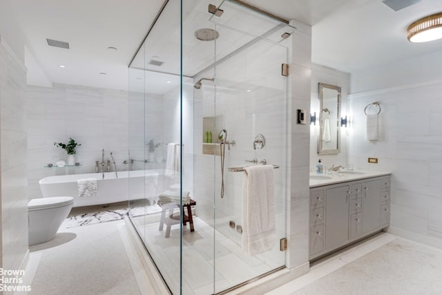 bathroom with vanity, tile walls, and plus walk in shower