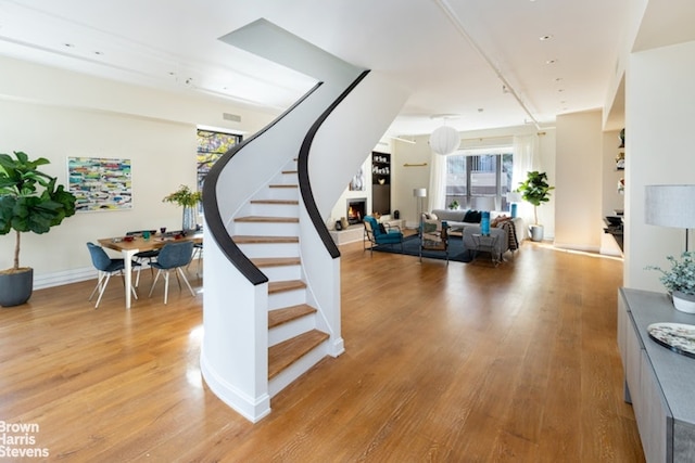 staircase with hardwood / wood-style floors