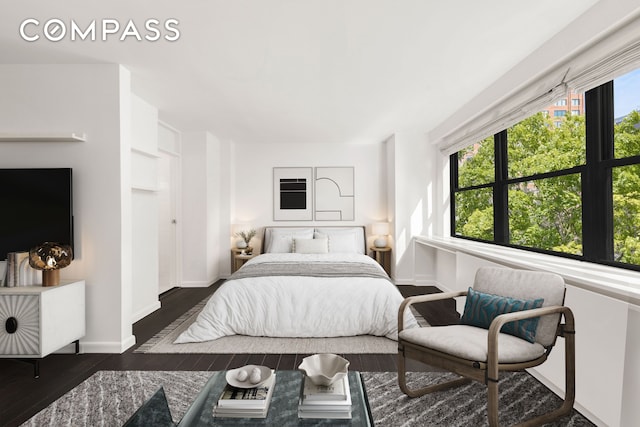 bedroom with wood finished floors and baseboards