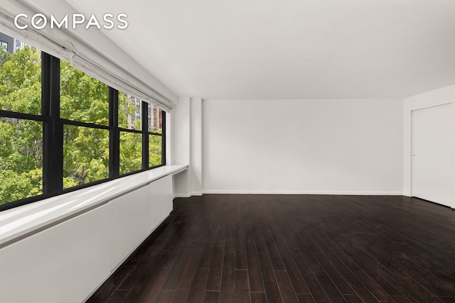 interior space featuring baseboards and wood finished floors