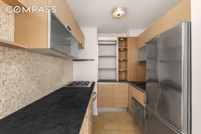 kitchen featuring dark countertops, light brown cabinets, decorative backsplash, appliances with stainless steel finishes, and open shelves