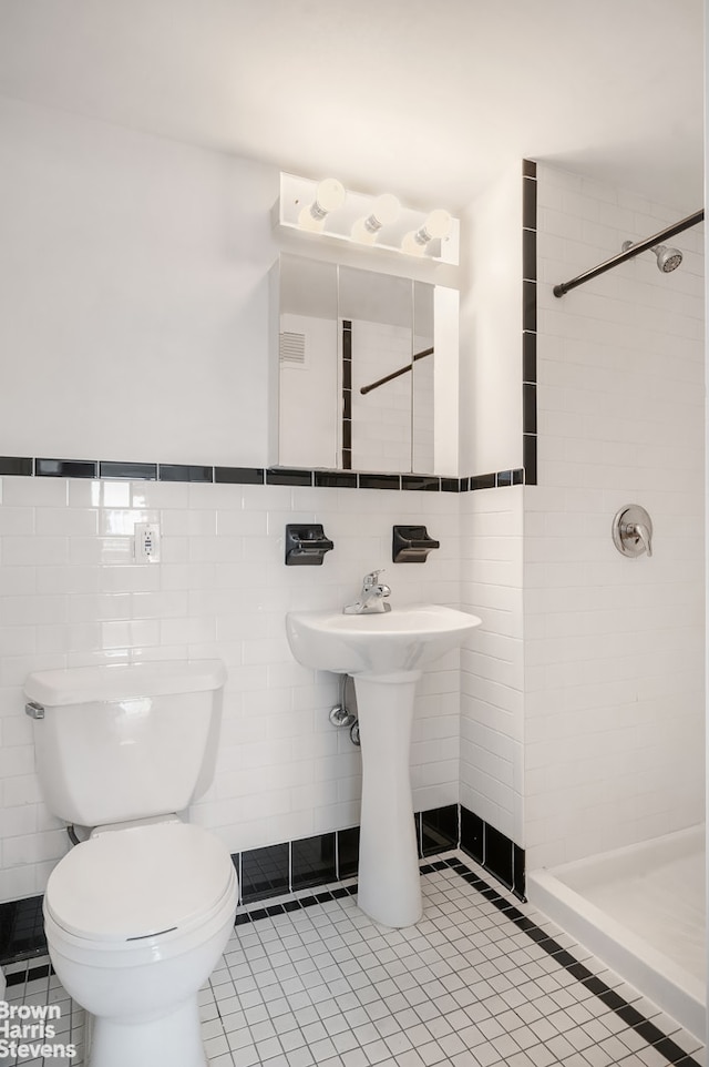 full bath featuring tile patterned flooring, toilet, visible vents, tile walls, and a stall shower