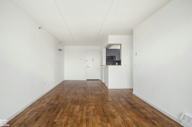 spare room with visible vents, baseboards, and wood finished floors