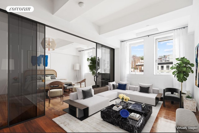 living area featuring visible vents and wood finished floors