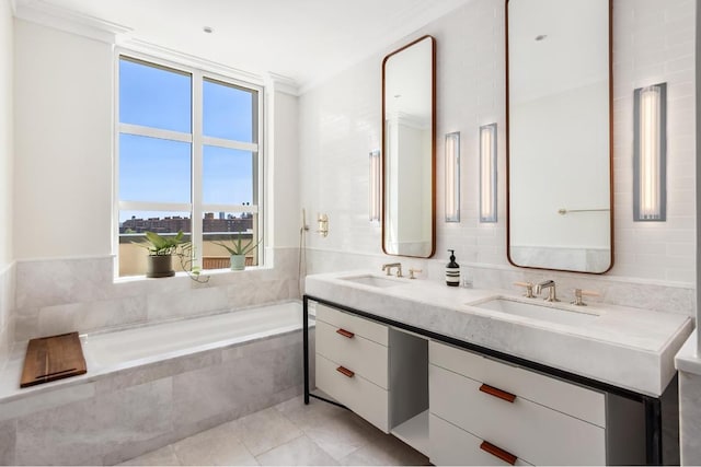 bathroom with a relaxing tiled tub, tile patterned floors, vanity, and ornamental molding