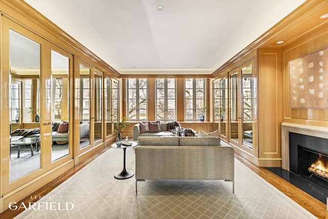 living room featuring a healthy amount of sunlight, hardwood / wood-style floors, and french doors