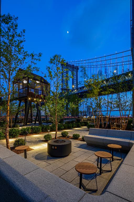 view of community featuring a patio area and an outdoor fire pit