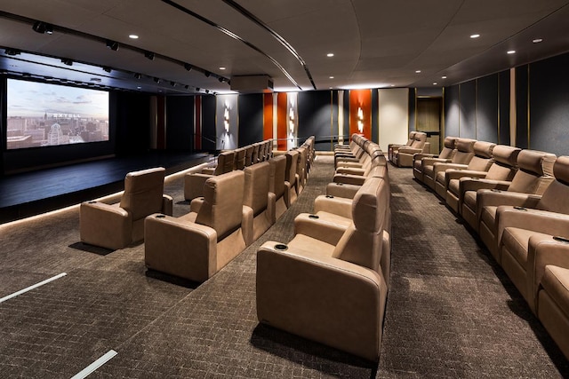 carpeted cinema room featuring track lighting