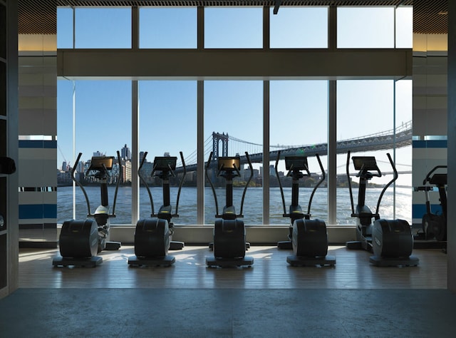 workout area featuring a water view