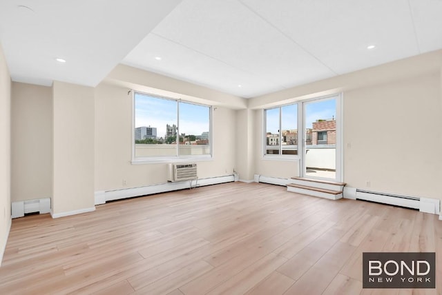 empty room featuring light hardwood / wood-style flooring and baseboard heating