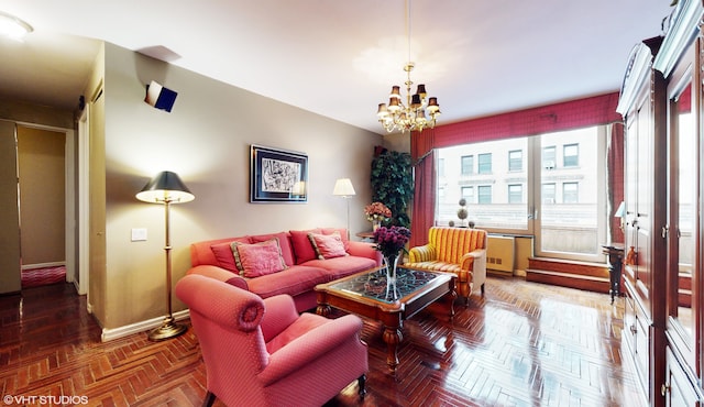 living area featuring a notable chandelier, plenty of natural light, and baseboards