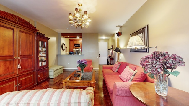 living room featuring a chandelier and baseboards