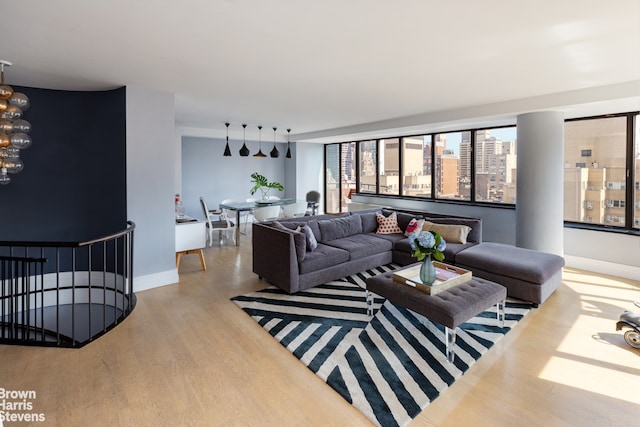 living area featuring a view of city, light wood-style flooring, and baseboards