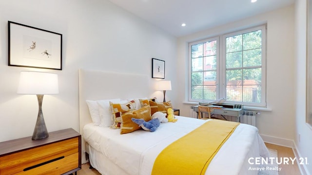 bedroom with recessed lighting, radiator, and baseboards