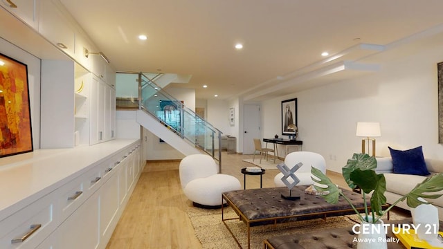 living area with light wood-style flooring, stairs, and recessed lighting