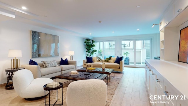 living room featuring light wood finished floors and recessed lighting