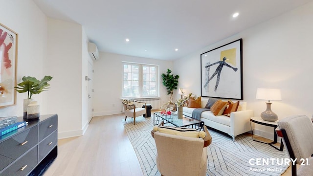 living area with recessed lighting, light wood-style flooring, baseboards, and a wall mounted AC