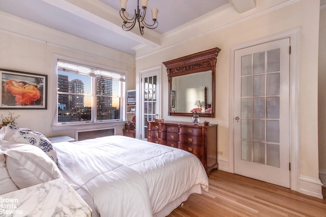 bedroom with a chandelier, light hardwood / wood-style flooring, and beamed ceiling