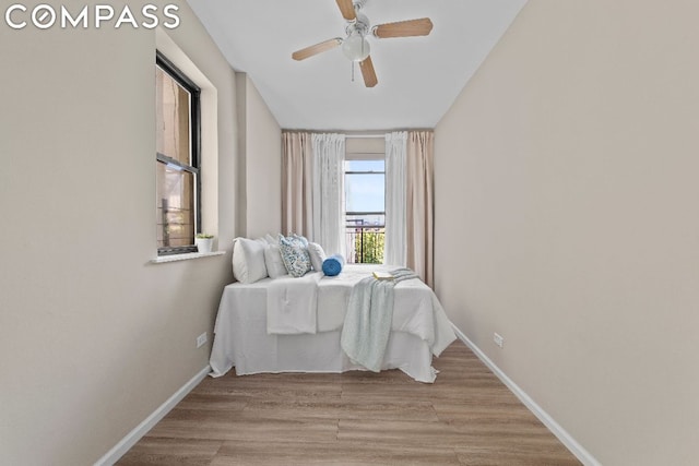 bedroom featuring ceiling fan and light hardwood / wood-style flooring