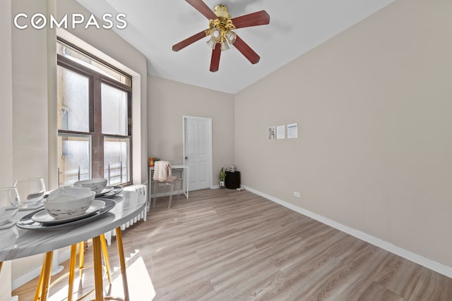 interior space featuring baseboards, light wood-style floors, and ceiling fan